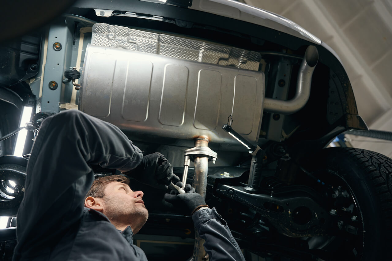 professional-male-checking-exhaust-resonator-in-th-2023-11-27-05-14-58-utc (1)
